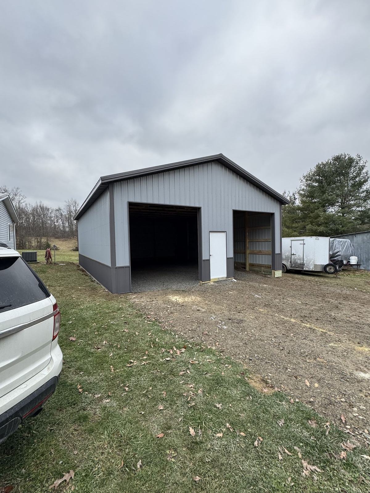 Gray barn with two open bays