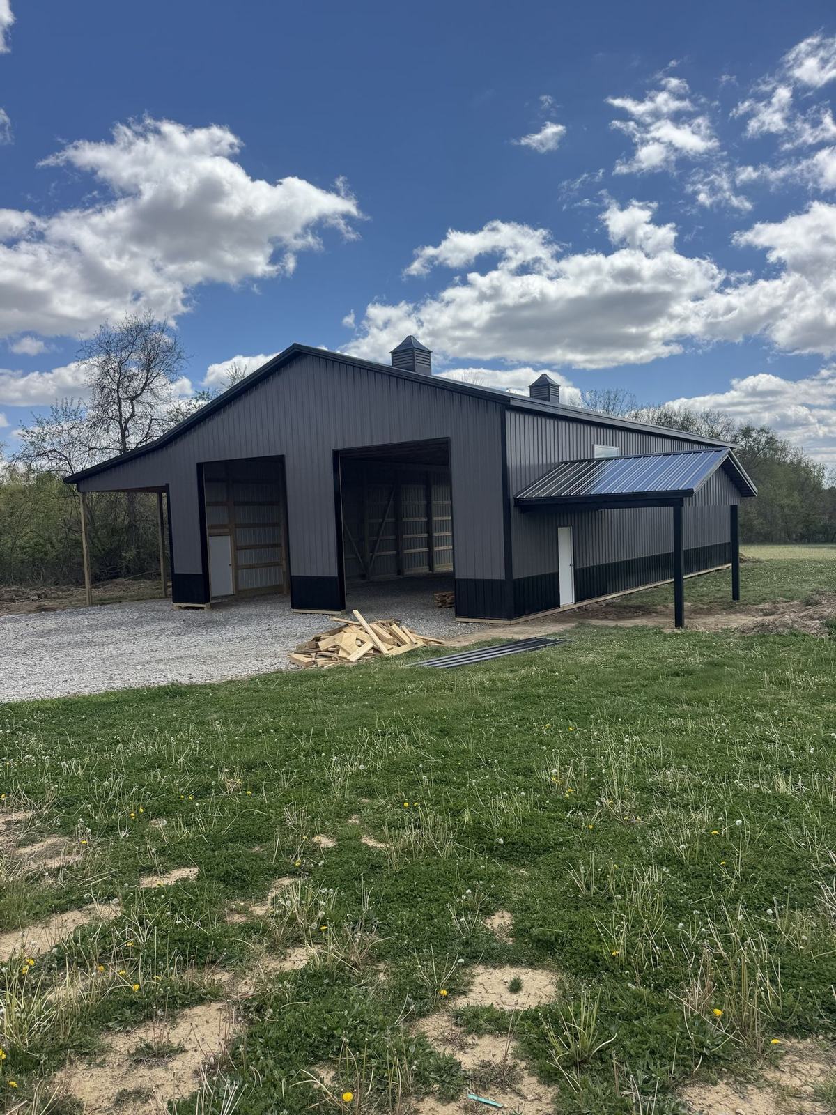Charcoal equipment barn with black wainscot and open bays