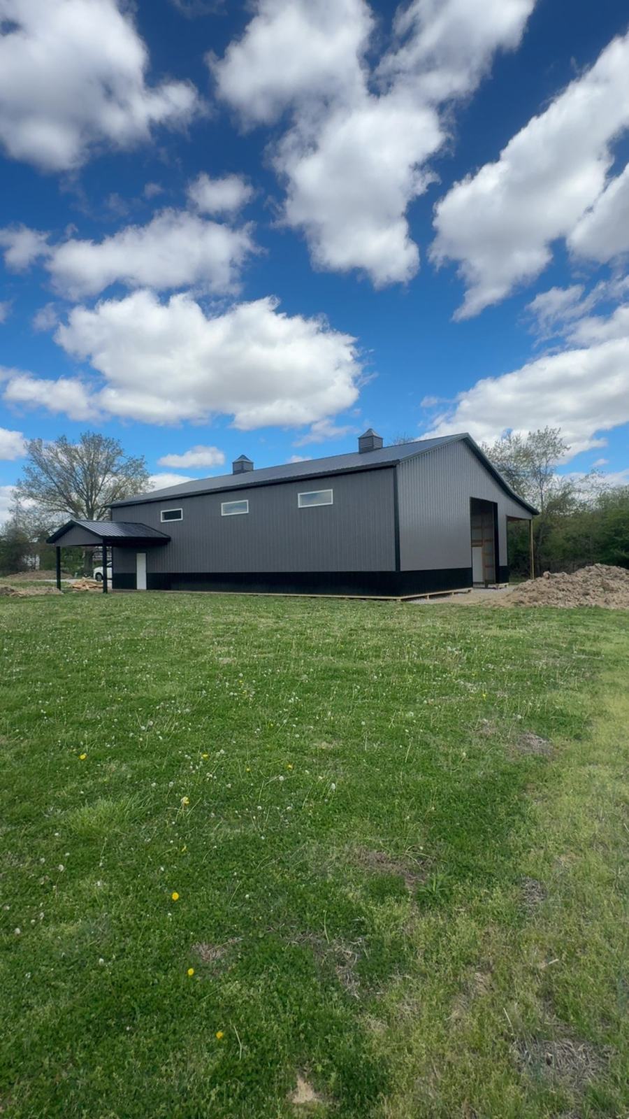 Side of a charcoal barn with windows and a lean-to