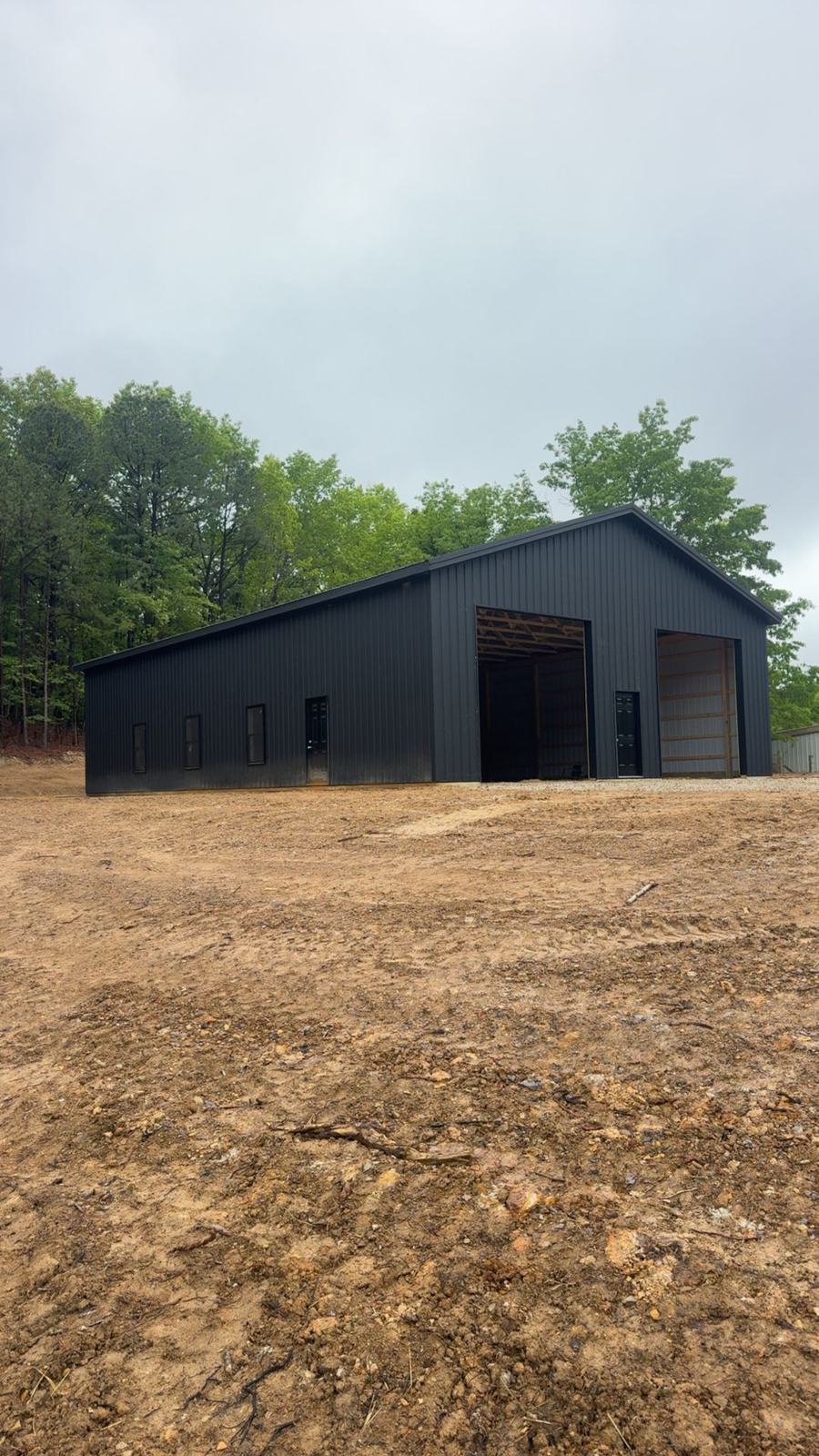 Long black barn with open bays