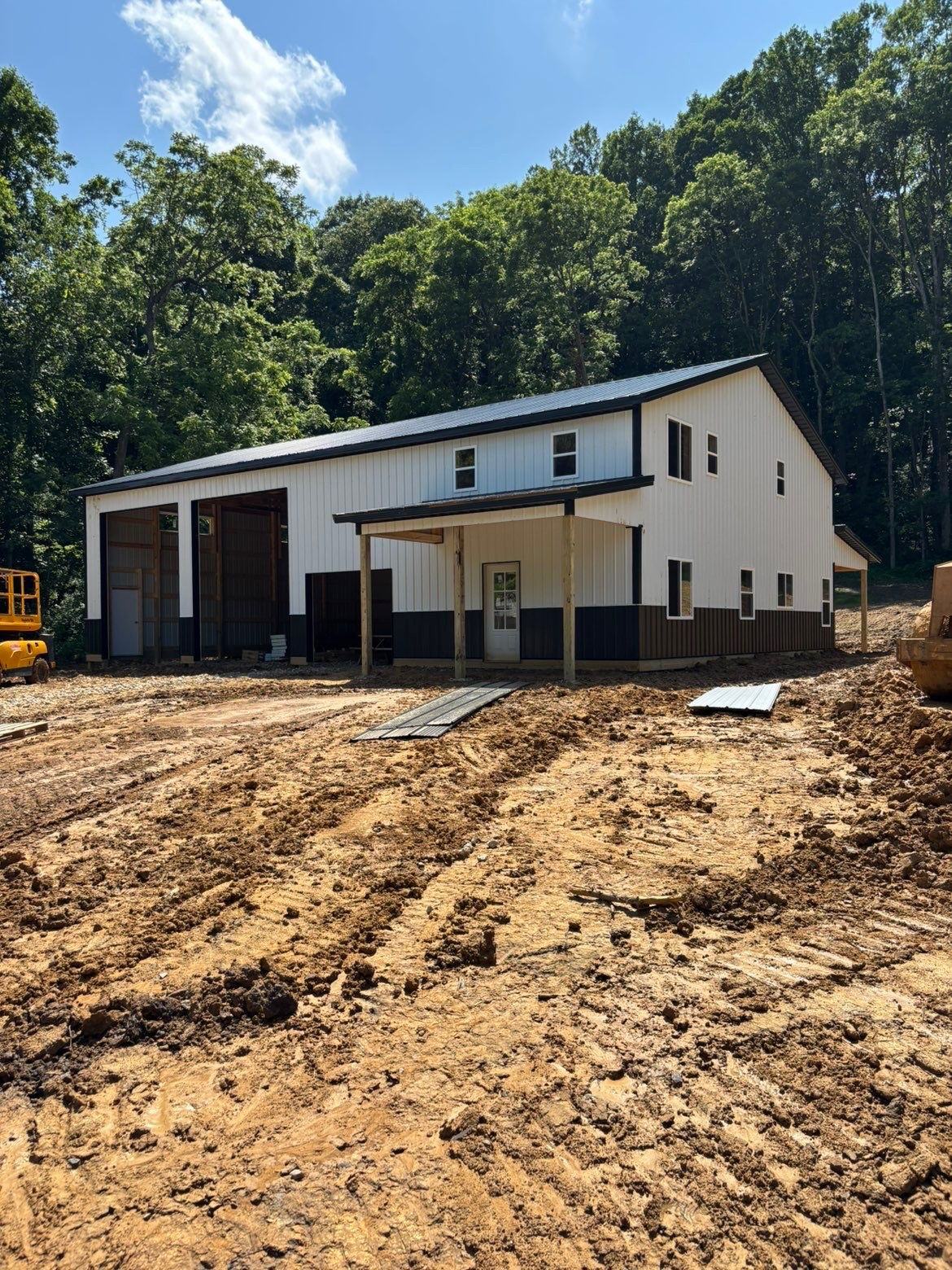 White two-story barn with shop bays